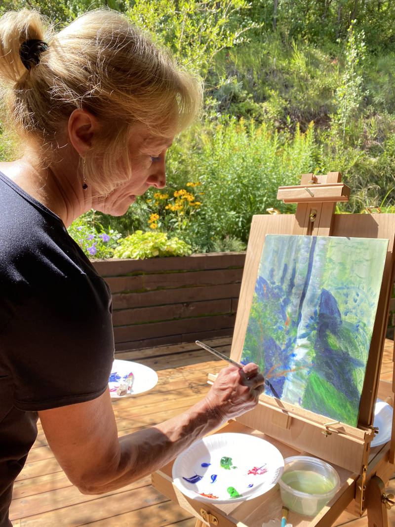 Adult participants smiling and holding their finished artwork at a Lea Art Studio event